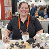 Woman smiling behind trade show booth